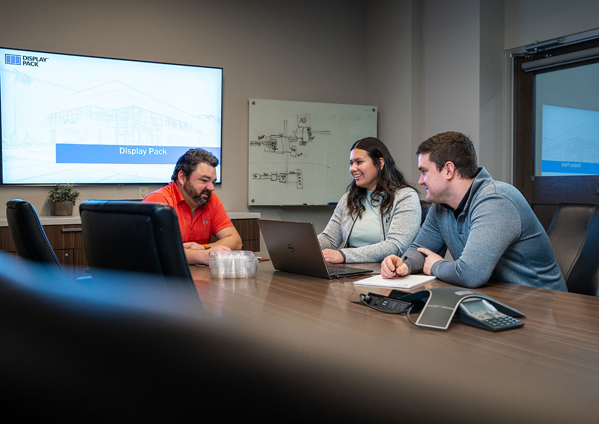 Employees chatting in brightly lit lounge space